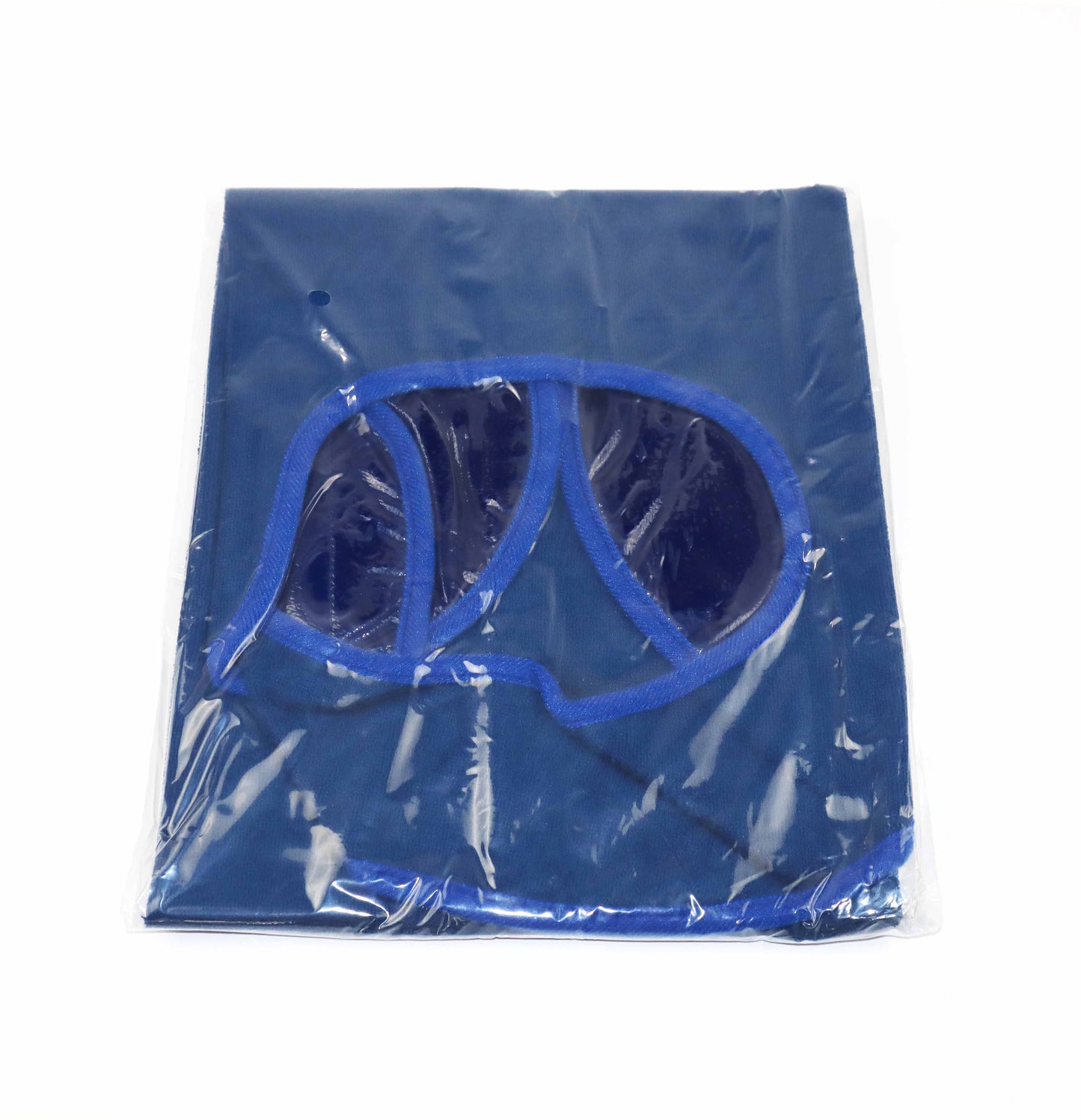The image shows a single packaged adult bib. The bib is folded and sealed in a clear, glossy plastic wrapper, allowing the dark blue fabric and light blue border to be visible. Through the transparent packaging, the rounded neck opening is evident, along with the blue Velcro strap designed for closure. The packaging appears to have a small hole at the top, likely for hanging the product for display. The plastic sheen indicates the item is brand new and has not been opened.